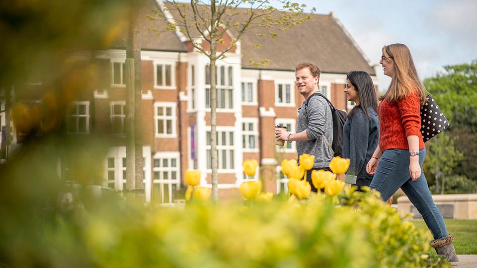 Students walking in front of Hazlerigg building on the ֱapp campus